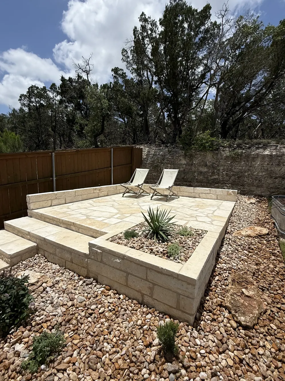 Masoned patio with a raised stone planter