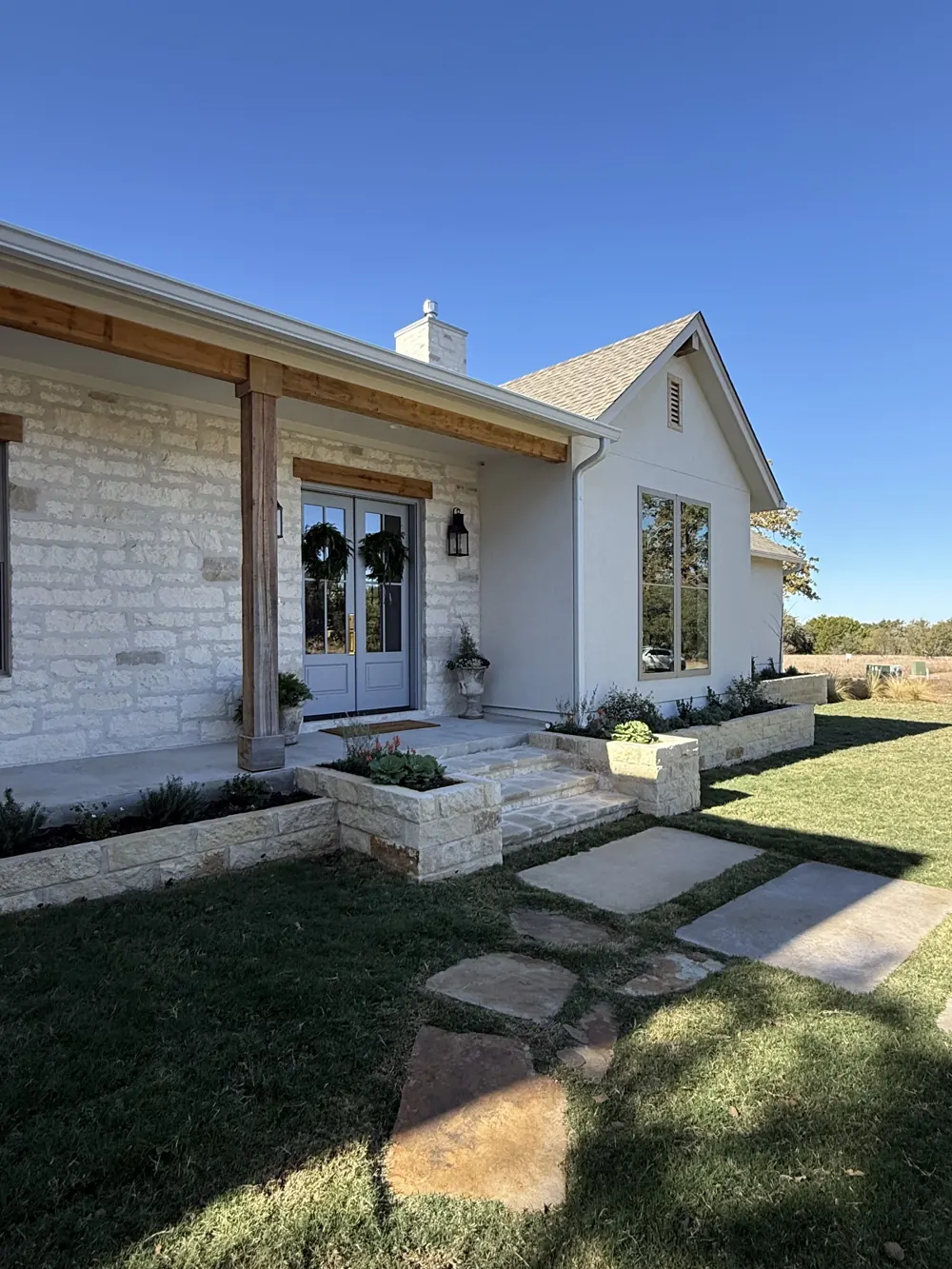 Raised masoned flower beds and stone entry steps