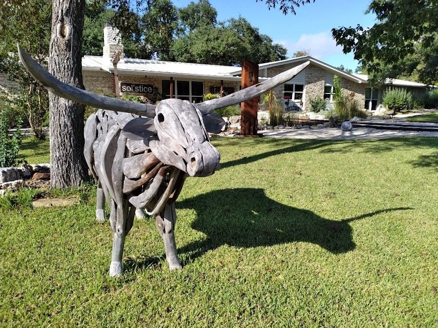 Longhorn sculpture on the lawn outside the original Solstice storefront