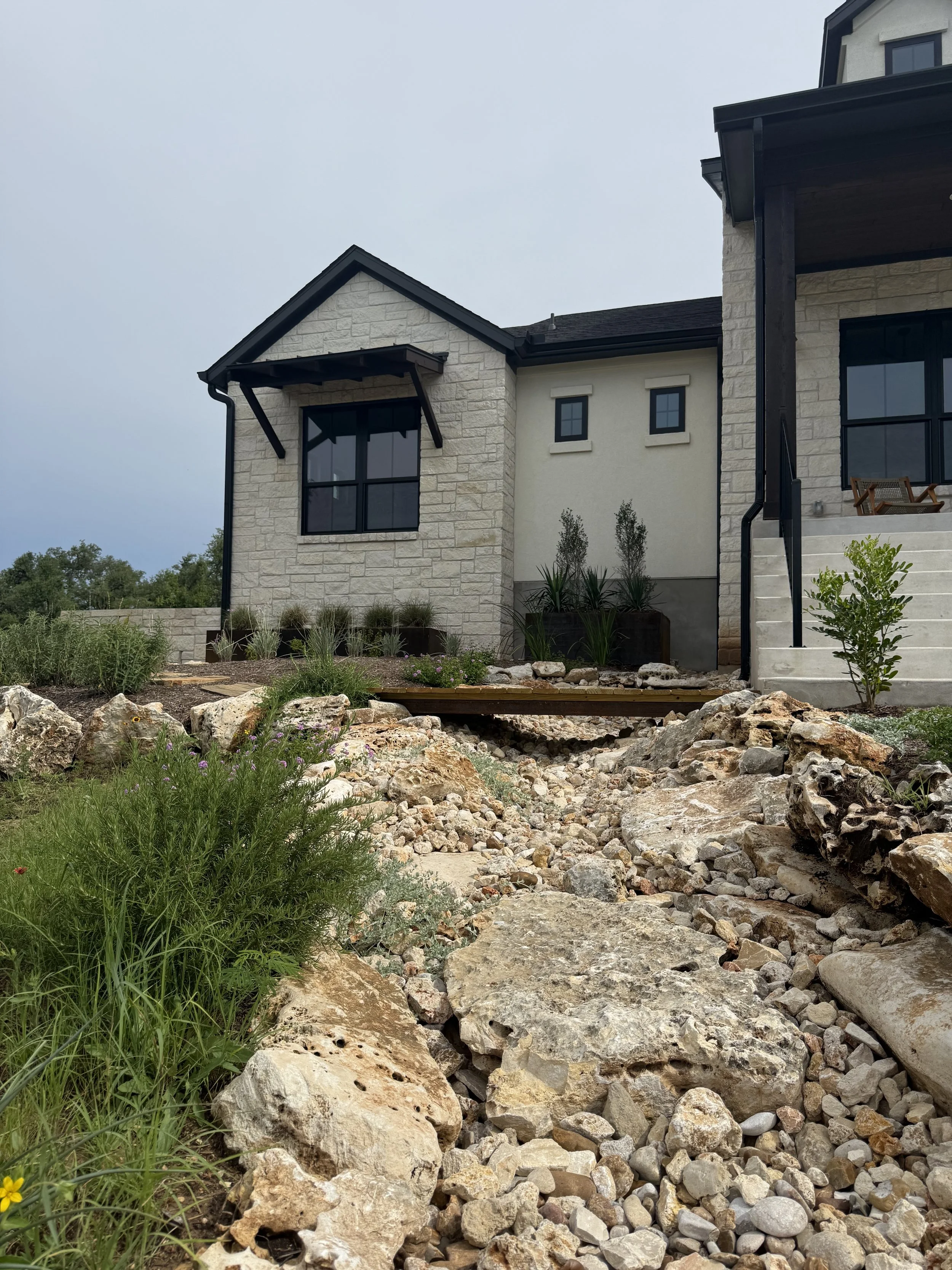 Dry creek drainage feature with stone