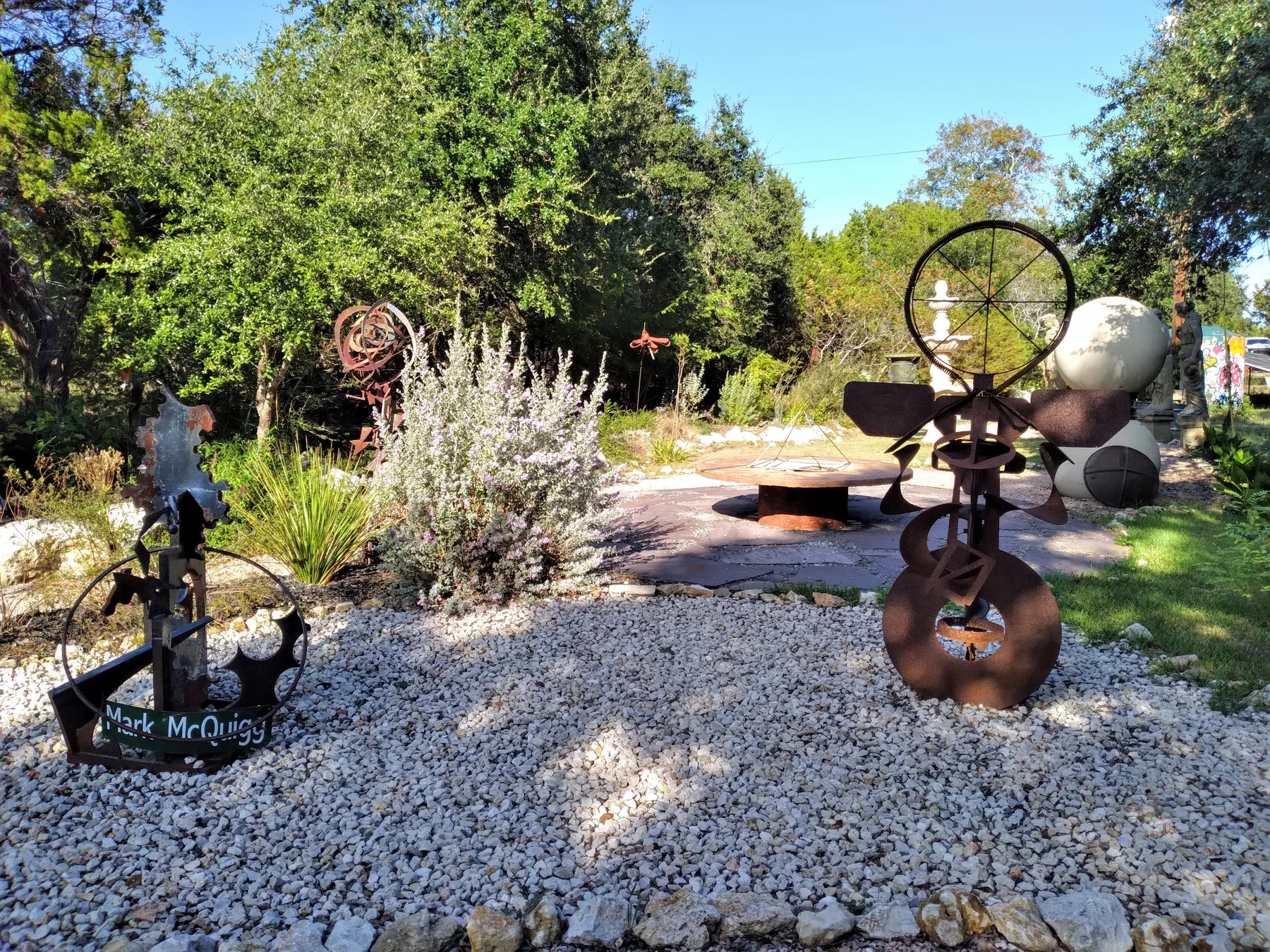 Sculpture garden with metal artwork, planting and gravel paths