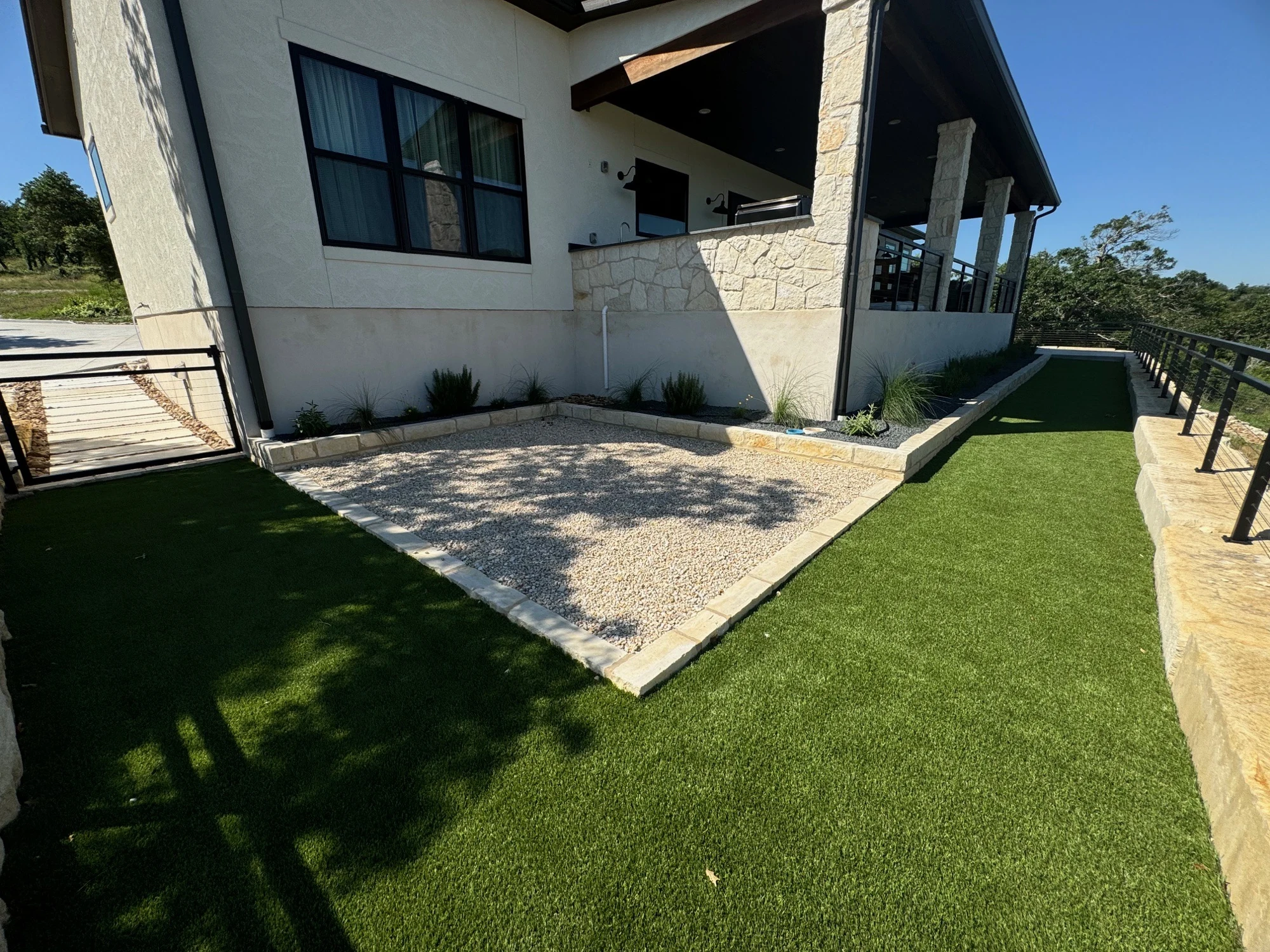 Artificial turf alongside a patio and modern home
