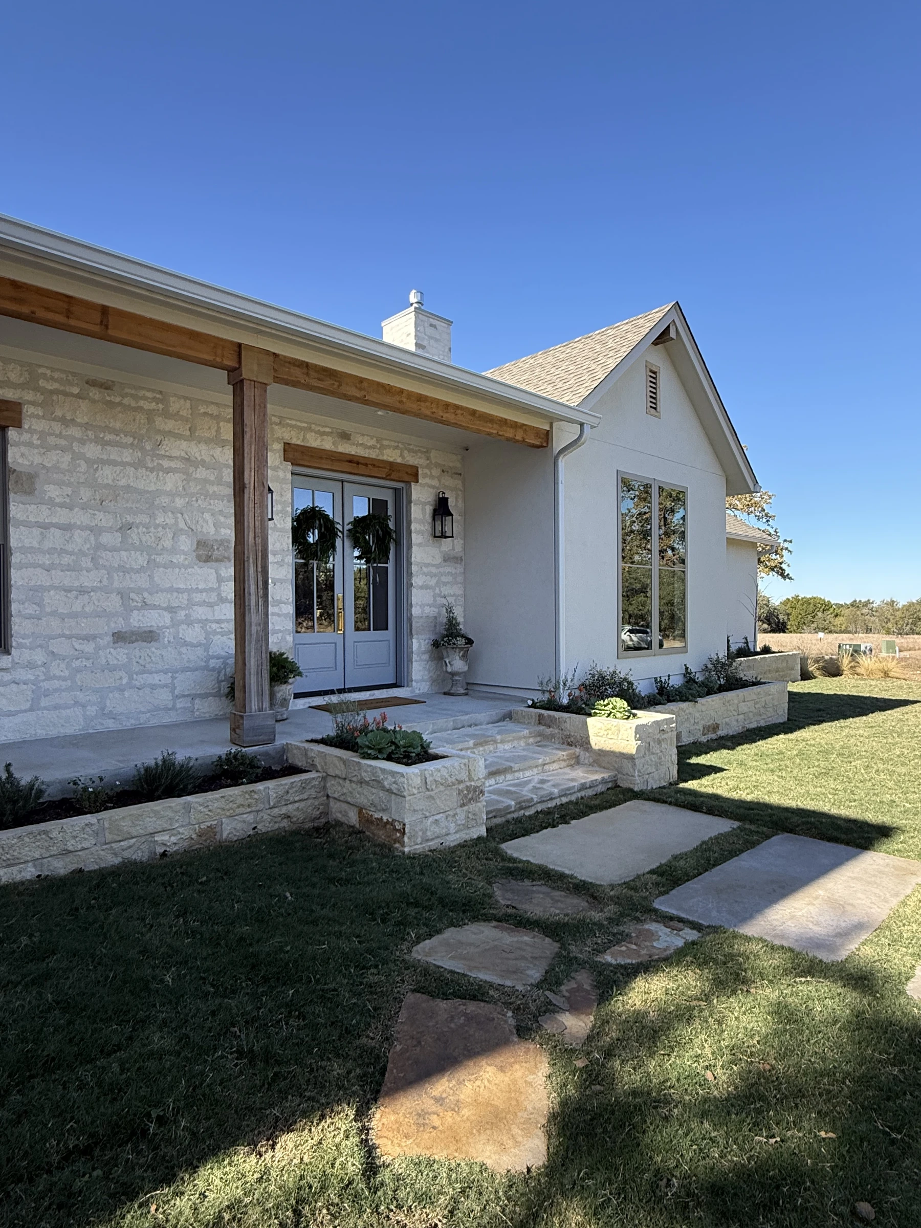 Raised masoned flower beds and stone entry steps
